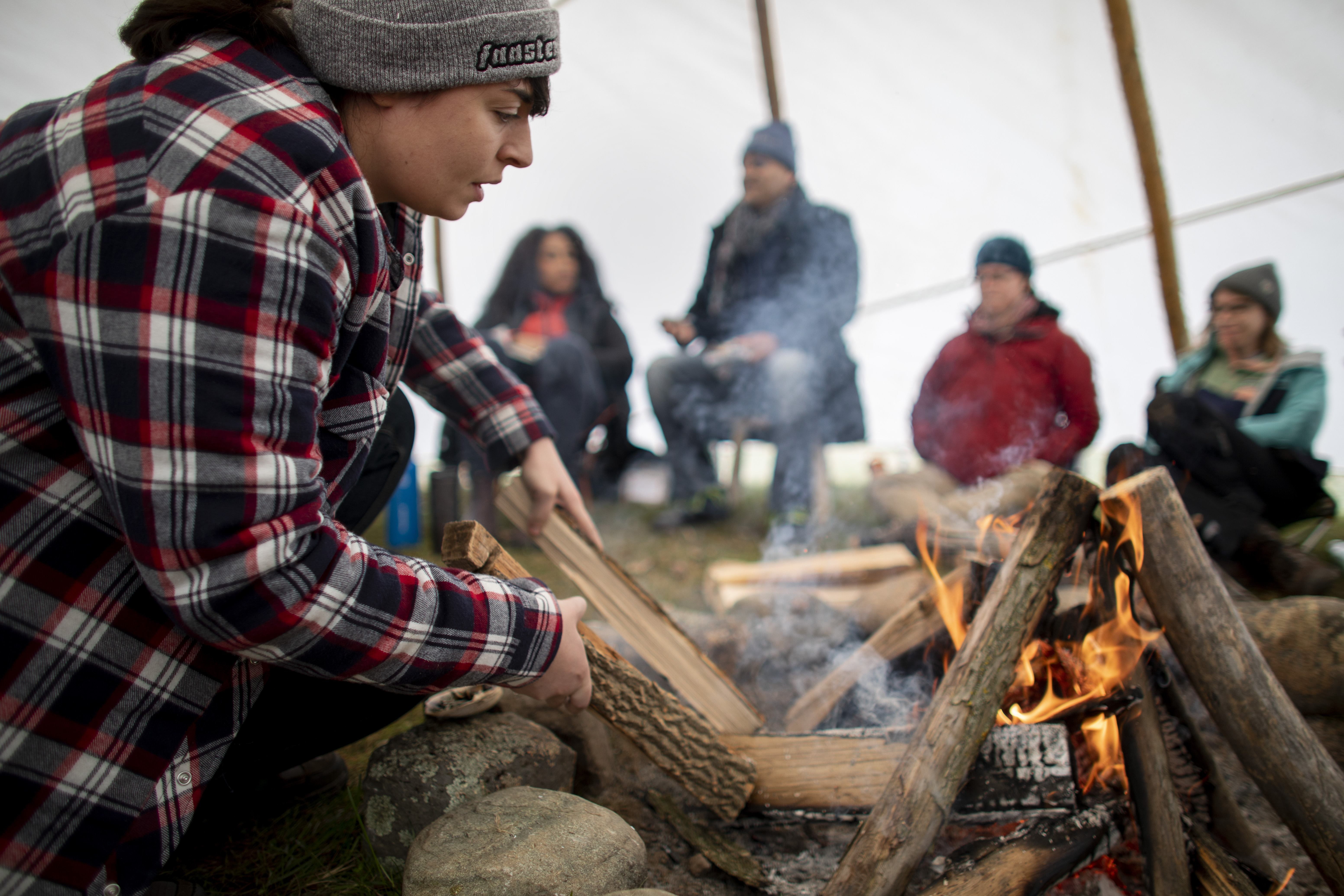 Students work at building a fire during a land-based Intensive Indigenous Health course,through the Dalla Lana School of Public Health at Hart House Farm,April 30,2019. (photo by Nick Iwanyshyn)